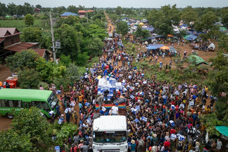 Displaced Cambodians receive water at the Battkhao Resettlement Camp in Oddar Meanchey province, Cambodia, July 26, 2025.